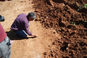 Nahide draws her plans in the soil